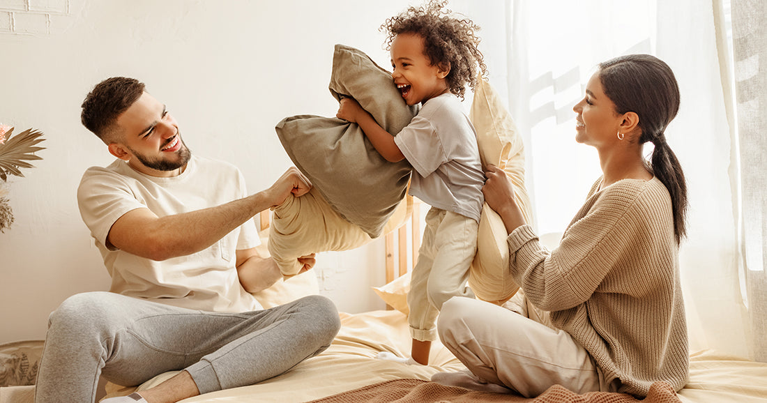 family playing pillow fight