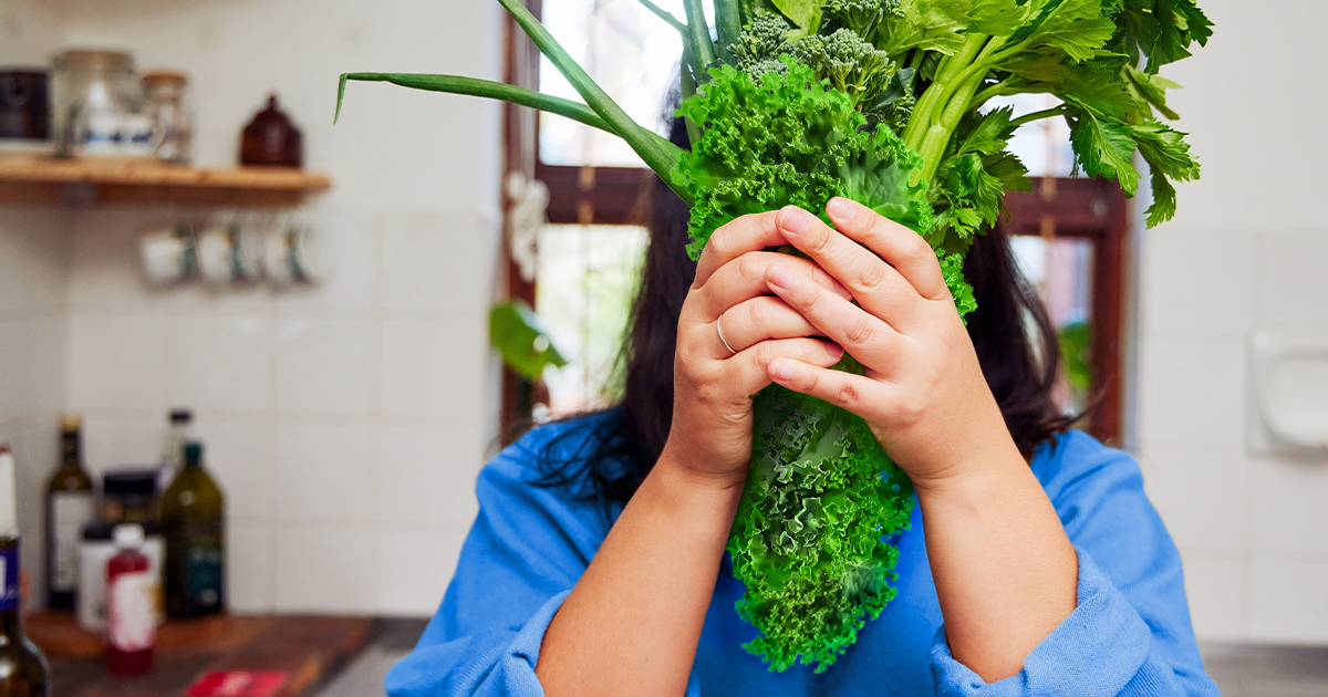 women holding a handful of leafy greens