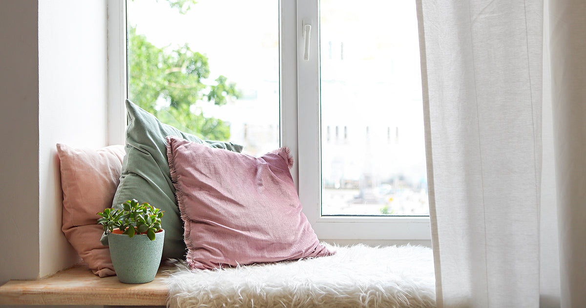 pillows on bench seat by window, calming relaxing wellness