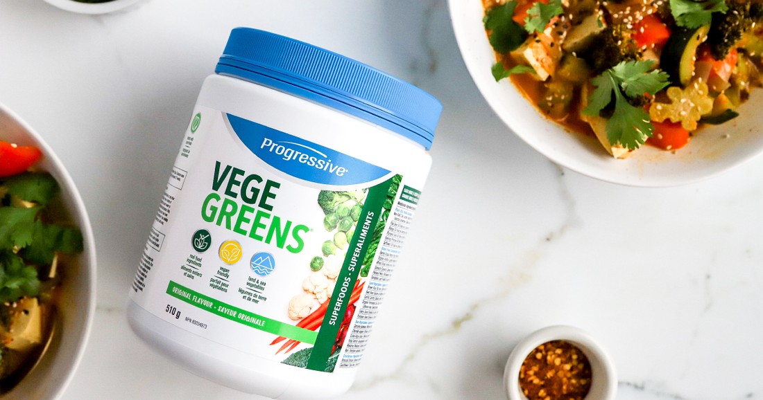 VegeGreens laying on a marble kitchen counter next to vegan coconut curry