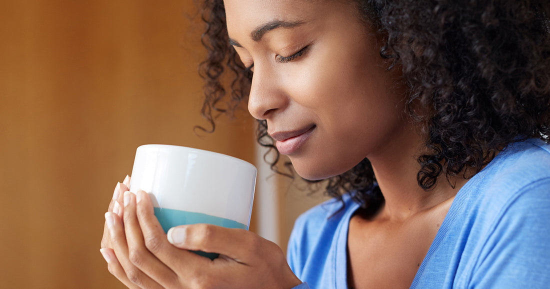 woman holding mug of bone broth