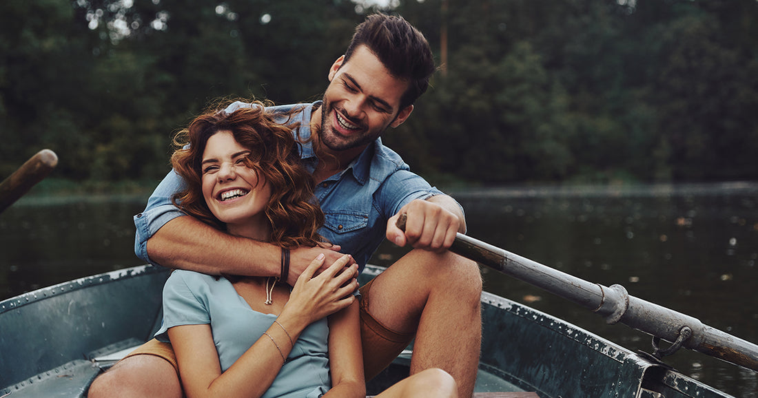 happy couple rowing a boat