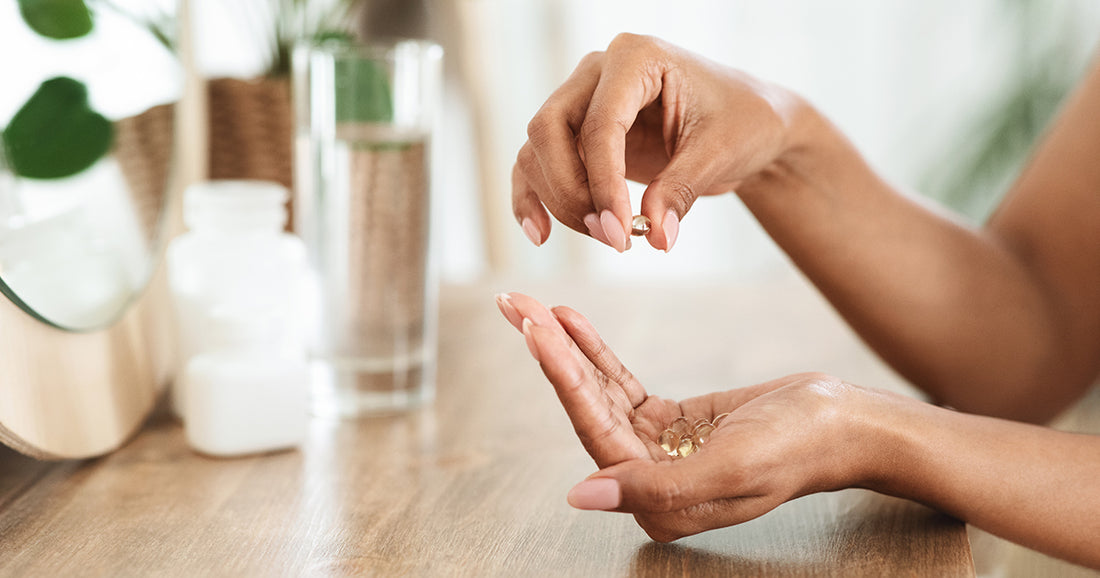 woman holding vitamins in her hand
